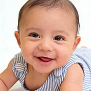 Barron joined the competition — help win amazing prizes! baby, child, infant, smiling, happy, portrait, face, eyes, brown_hair, open_mouth, striped_clothing, blue_clothing, sleeveless_outfit, lying_down, close_up, indoor, bright_background, photography, adorable, gummy_smile