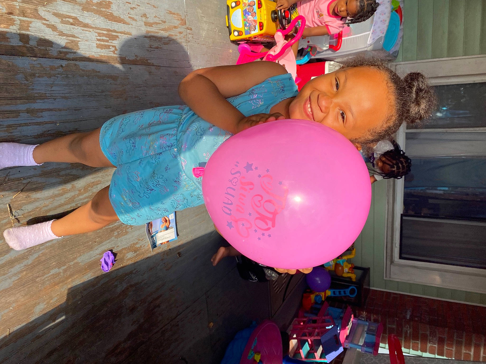 Legaci is registered to the contest to win money with this photo: balloon, blue, child, electric_blue, event, flooring, fun, happy, hardwood, hat, human_leg, joy, leisure, party_supply, person, pink, smile, snapshot, t_shirt, thigh