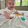 Bodie joined the competition — help win amazing prizes! baby, blanket, child, crawling, cute, door, face, floor, hand, happy, home, indoor, infant, natural_light, pacifier, person, smiling, striped_clothing, toy, window