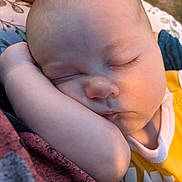 Bodie joined the competition — help win amazing prizes! baby, sleeping, face, arm, closeup, peaceful, infant, skin, head, eyelashes, yellow_clothing, soft_light, hand, outdoor, blanket, resting, portrait, child, cute, relaxed