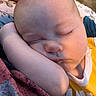 baby, sleeping, face, arm, closeup, peaceful, infant, skin, head, eyelashes, yellow_clothing, soft_light, hand, outdoor, blanket, resting, portrait, child, cute, relaxed