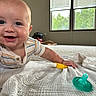 Bodie is registered to the contest to win money with this photo: baby, blanket, blinds, bright, carpet, child, cute, face, hand, happy, home, indoor, infant, lying_down, pacifier, person, playtime, smiling, toy, window