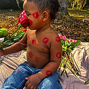 Axl James is registered to the contest to win money with this photo: blanket, child, cute, flower, grass, greenery, happy, jeans, kiss_marks, lipstick_marks, nature, outdoor, playing, portrait, rose, shirtless, sitting, sunlight, toddler, tree