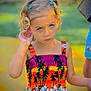 Aria participe au concours pour gagner de l'argent avec cette photo : child, girl, blue_eyes, curly_hair, colorful_dress, tropical_pattern, outdoor, summer, portrait, serious_expression, sunlight, green_background, yellow_background, pigtails, fashion, person, cute, young, standing, nature