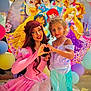 child, princess, costume, face_paint, tiara, balloons, disney_princesses, heart_shape, smile, dress, purple_top, mermaid_skirt, pink_gown, woman, celebration, party, happy, outdoor, portrait, colorful
