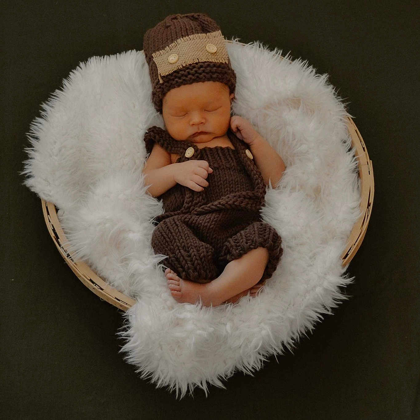 Elijah is registered to the contest to win money with this photo: art, baby, beanie, cap, child, comfort, costume_hat, fashion_accessory, fawn, freezing, fur, fur_clothing, knit_cap, linens, sitting, textile, toddler, wood, wool, woolen