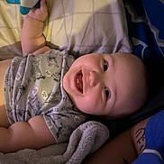 Michael joined the competition — help win amazing prizes! baby, smiling, toy, blanket, infant, cute, happy, child, lying_down, clothing, bed, comfort, skin, face, hand, soft_toy, pajamas, sleepwear, indoors, person