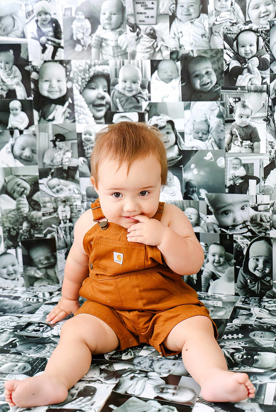 Michael is registered to the contest to win money with this photo: baby, child, infant, overalls, sitting, floor, photographs, collage, black_and_white, portrait, cute, curious, smiling, indoor, clothing, skin, face, hand, foot, expression