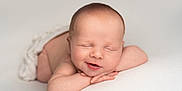 Vinnie is registered to the contest to win money with this photo: newborn, baby, sleeping, smiling, infant, resting, arms, face, skin, head, peaceful, white_background, blanket, soft, portrait, cute, closeup, child, tiny, wrapped
