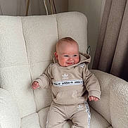 Vinnie joined the competition — help win amazing prizes! baby, child, smile, hoodie, pants, adidas, tracksuit, armchair, furniture, indoor, curtains, cozy, fashion, comfortable, happy, person, sitting, cute, infant, portrait