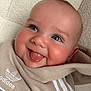 baby, tongue, smile, blue_eyes, hoodie, adidas, clothing, closeup, face, infant, cute, playful, child, happy, soft_texture, indoor, portrait, person, sweatshirt, casual