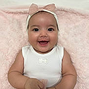 Arabella is registered to the contest to win money with this photo: baby, blanket, bow, child, clothing, cute, eyes, fabric, face, hands, happy, headband, infant, pink, portrait, skin, smiling, soft, toddler, white