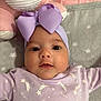 baby, infant, headband, bow, purple, onesie, stars, moon, blanket, soft_toy, plush, close_up, face, eyes, mouth, cute, child, portrait, sleepwear, laying_down