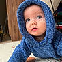 baby, infant, child, blue_hoodie, knit_sweater, big_eyes, curious, crawling, play_mat, smile, portrait, indoors, floor, wooden_panel, toy_shelf, soft_light, skin, cute, hood, expression