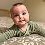 baby, infant, child, onesie, bed, bedding, patterned_bedspread, portrait, close_up, blue_eyes, crawling, cute, expression, soft_lighting, bokeh, indoor, home, chubby_cheeks, head, headboard
