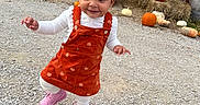 Ayla is registered to the contest to win money with this photo: autumn, barn, child, cute, decoration, fall, festive, gravel, hay_bales, orange_dress, outdoor, pigtails, pink_boots, pumpkin, rustic, seasonal, smiling, toddler, walking, white_shirt