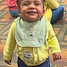 Ayla joined the competition — help win amazing prizes! bib, black_shoes, carpet, casual, child, curly_hair, cute, denim_skirt, expression, family, happy, indoor, people, playgroup, portrait, sitting, smiling, toddler, yellow_cardigan, young_child