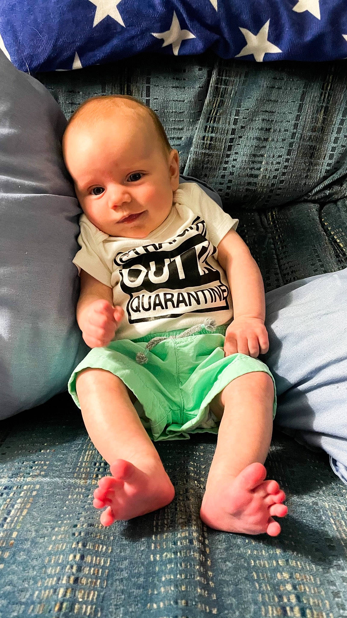 Tucker is registered to the contest to win money with this photo: baby, baby_toddler_clothing, cheek, comfort, couch, eye, face, finger, flash_photography, fun, happy, head, human_body, iris, leg, person, skin, sleeve, smile, thigh