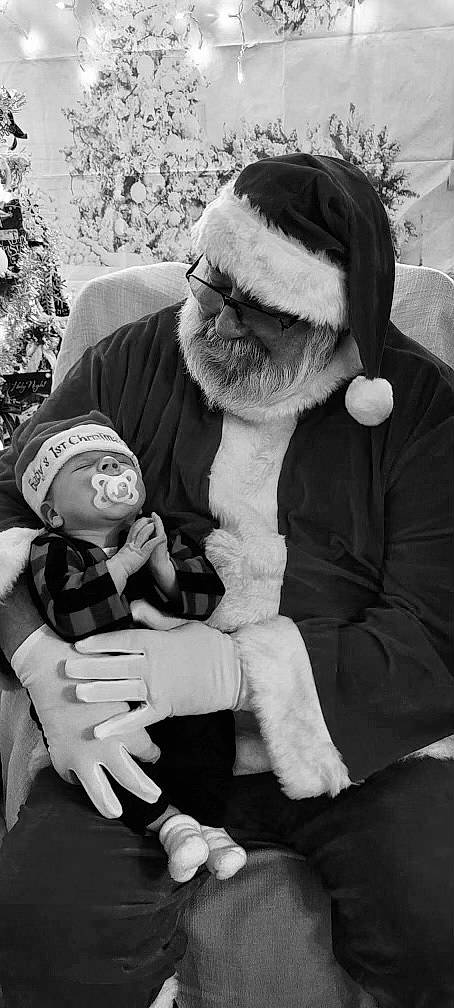 Parker is registered to the contest to win money with this photo: arm, baby, beard, black, cap, fun, fur_clothing, gesture, hand, happy, hat, headgear, human_body, monochrome, monochrome_photography, outerwear, person, style, sunglasses, tree
