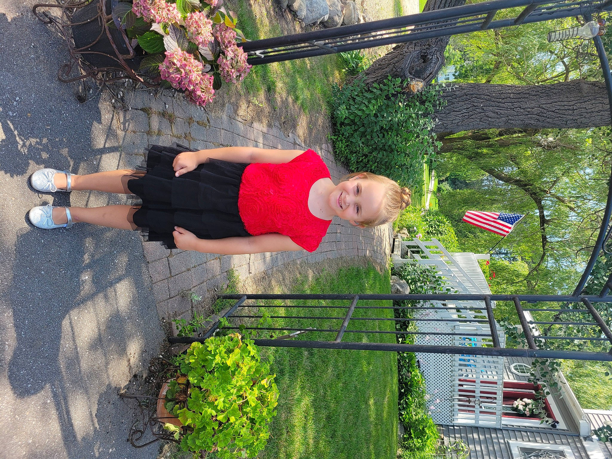 Shauna is registered to the contest to win money with this photo: flower, fun, garden, grass, hat, human_leg, joy, landscape, leisure, people_in_nature, person, physical_fitness, plant, recreation, shorts, shrub, smile, t_shirt, thigh, tree