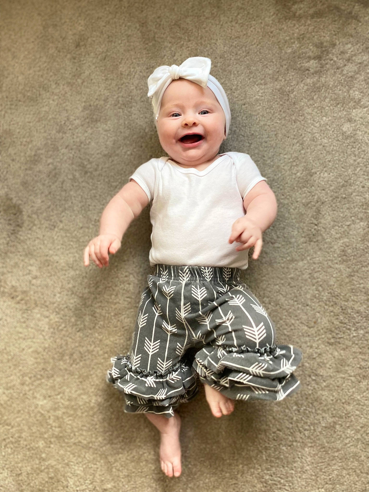 Saige is registered to the contest to win money with this photo: baby, baby_toddler_clothing, barefoot, child, day_dress, foot, fun, grass, happy, hat, headwear, pattern, people_in_nature, person, play, portrait_photography, sitting, sleeve, smile, t_shirt