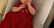 Victoria joined the competition — help win amazing prizes! baby, infant, red_dress, headband, cushion, hand, fingers, feet, indoor, person, child, cute, lying_down, fabric, texture, floor, wood_floor, clothing, portrait, relaxing
