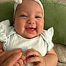 Victoria joined the competition — help win amazing prizes! baby, infant, smiling, happy, headband, white_clothing, hand, adult_hand, couch, cushion, indoor, portrait, cute, child, person, closeup, skin, fingers, soft_toys, baby_girl