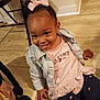 Khaycee is registered to the contest to win money with this photo: toddler, child, smiling, pink_bow, denim_jacket, toy, floor, tile, pants, sitting, happy, indoor, person, cute, playful, young_child, clothing, hand, face, hair