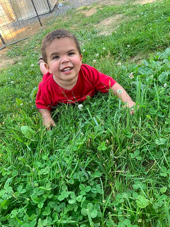 Keenan joined the competition — help win amazing prizes! agriculture, field, flowering_plant, grass, grass_family, grassland, groundcover, happy, joy, lawn, leaf, leaf_vegetable, meadow, people_in_nature, person, plant, prairie, shirt, shrub, smile