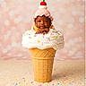 baby, cherry, child, crocheted_hat, cute, dessert, face, ice_cream, ice_cream_cone, infant, pastel_background, photography, pink, portrait, sitting, smiling, soft_lighting, sprinkles, studio, whipped_cream