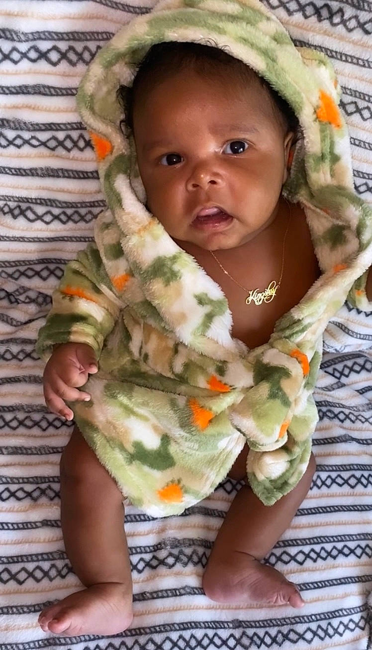 Kingsley is registered to the contest to win money with this photo: baby, baby_products, baby_safety, baby_toddler_clothing, cap, cheek, child, comfort, eye, face, green, happy, linens, nail, pattern, people_in_nature, person, skin, sleeve, thumb