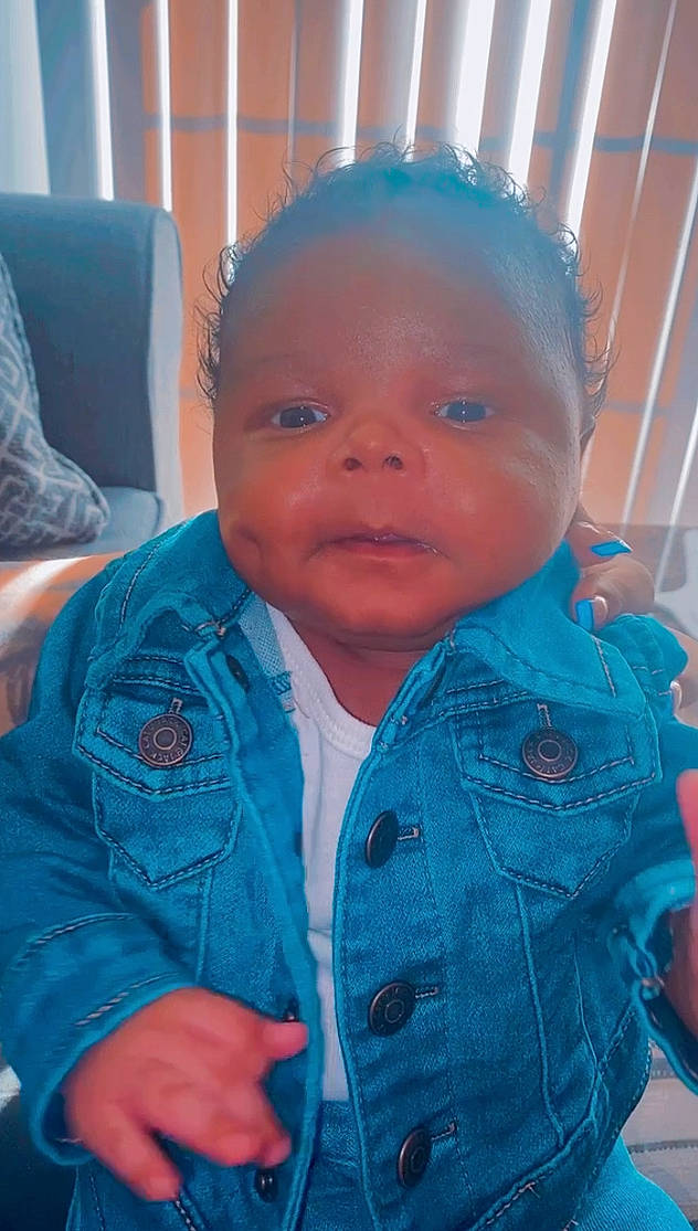 Kingsley is registered to the contest to win money with this photo: azure, baby_toddler_clothing, blue, cheek, chin, eye, face, finger, forehead, hairstyle, happy, iris, lip, mouth, nose, person, skin, sleeve, smile, standing