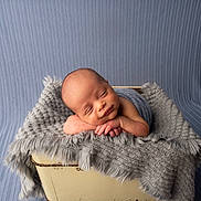 Shane is registered to the contest to win money with this photo: baby, basket, blanket, blue, child, cozy, cute, gray, infant, knit, newborn, peaceful, portrait, resting, sleeping, smiling, soft, studio, texture, wrapped