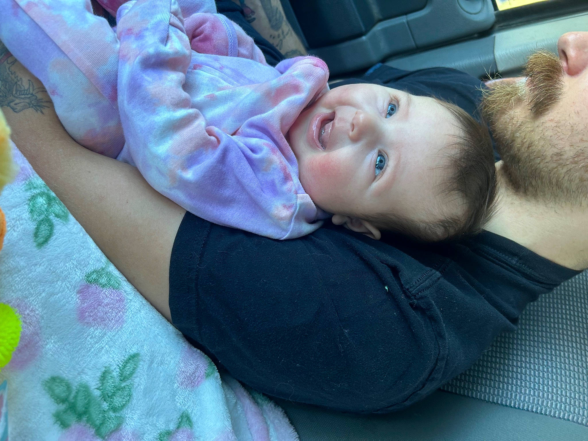Kinsley is registered to the contest to win money with this photo: baby, baby_toddler_clothing, beard, car_seat, child, comfort, elbow, family_car, fun, happy, linens, luxury_vehicle, mouth, nose, person, sitting, skin, smile, toddler, tree