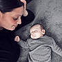 Eyden participe au concours pour gagner de l'argent avec cette photo : woman, baby, sleeping, gray_clothing, gray_background, face, peaceful, resting, portrait, closeup, indoors, soft_texture, hand, mother, newborn, cozy, calm, tender_moment, family, love