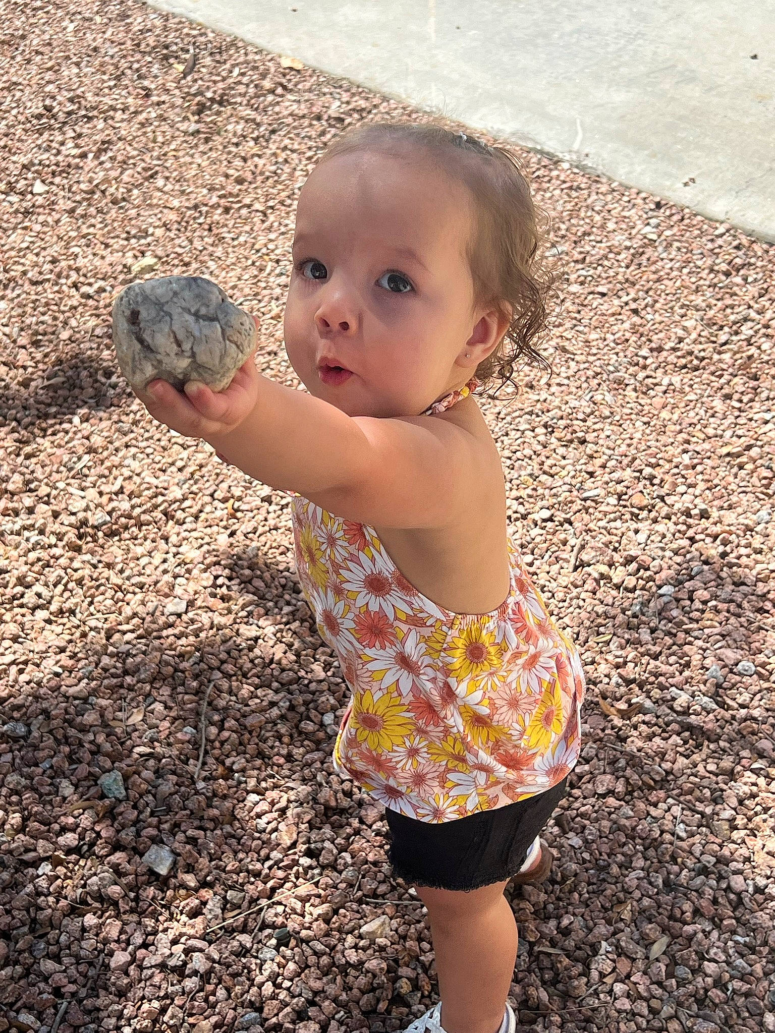 Kynleigh is registered to the contest to win money with this photo: asphalt, baby, baby_toddler_clothing, child, finger, fun, grass, hairstyle, hand, happy, human_leg, leaf, people_in_nature, person, play, shadow, soil, standing, toddler, vacation