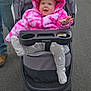 baby, infant, stroller, pink_jacket, hood, tie_dye, smile, happy, outdoor, road, asphalt, gray_stroller, cup_holder, bravo_brand, winter_clothing, sock, adult_leg, walking, parked_cars, hooded_coat
