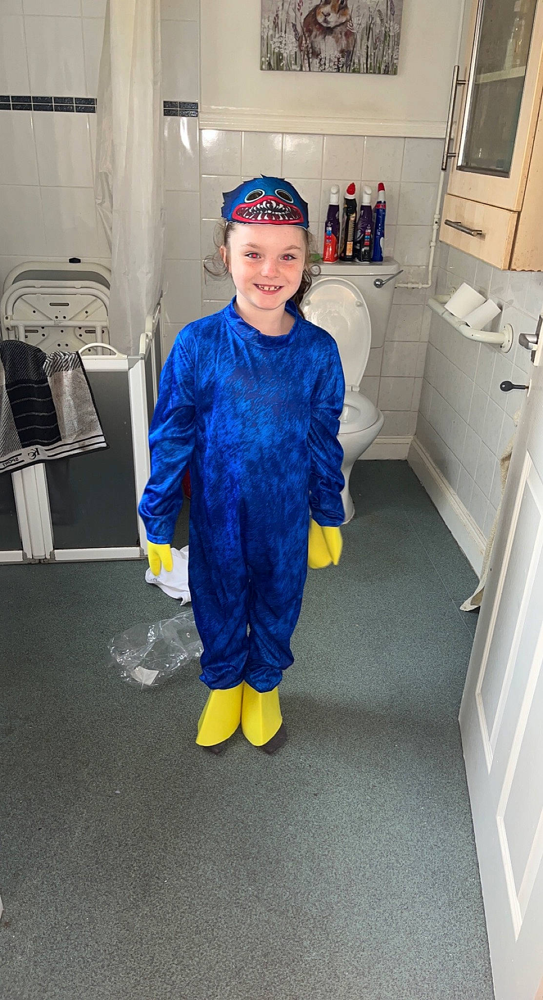 Lucia is registered to the contest to win money with this photo: cabinetry, child, door, electric_blue, face, fashion_design, flooring, gas, headwear, joy, kitchen_appliance, machine, major_appliance, person, personal_protective_equipment, refrigerator, room, sleeve, smile, sweatpant