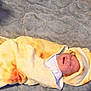 baby, newborn, blanket, yellow, orange, wrapped, hood, sleeping, crying, infant, soft, texture, gray, lying_down, cute, person, child, indoors, warm, cozy