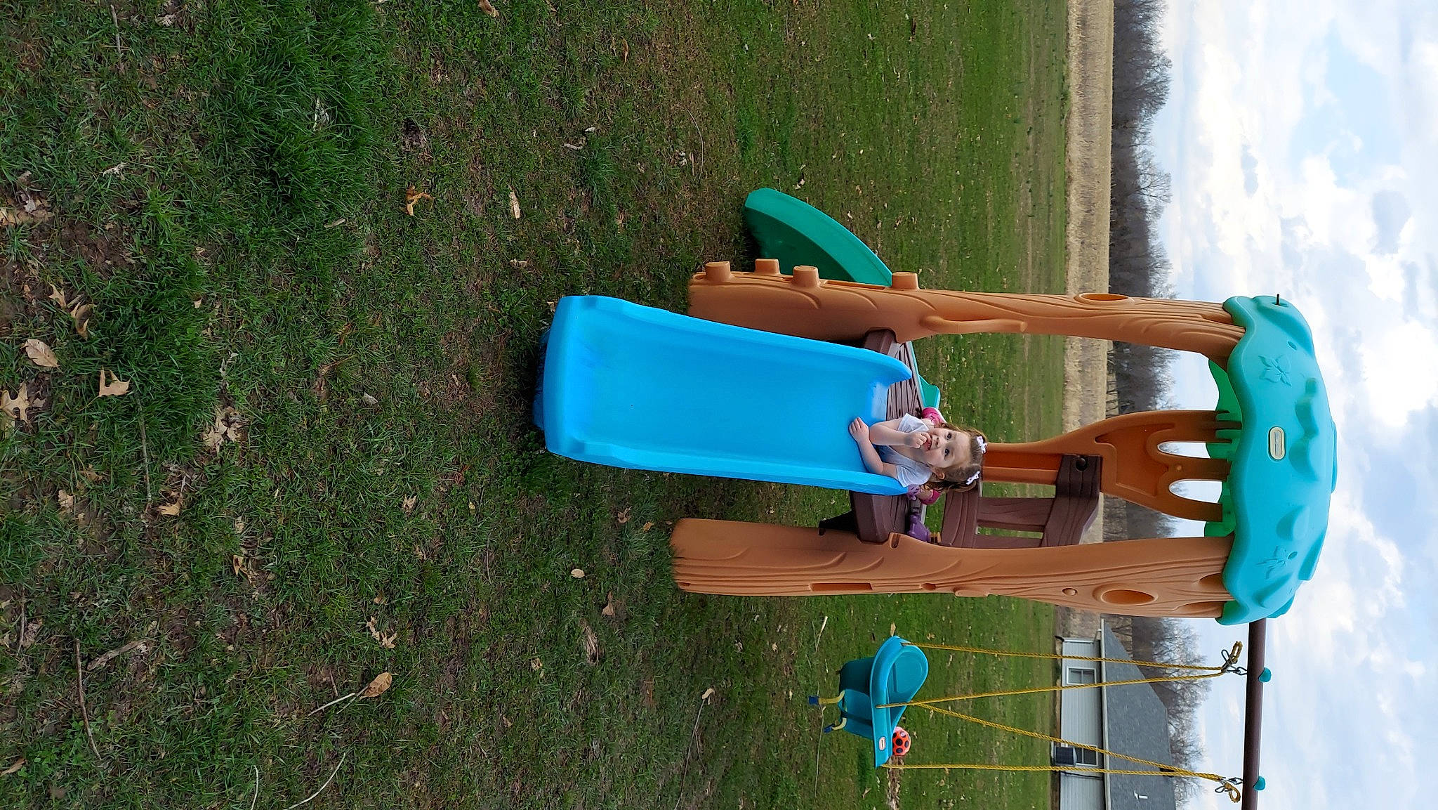 Lilian joined the competition — help win amazing prizes! calf, chute, city, electric_blue, fun, grass, human_leg, knee, leisure, outdoor_furniture, outdoor_play_equipment, people_in_nature, person, plastic, recreation, shorts, sky, thigh, water