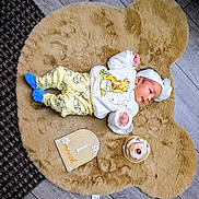 Durvi joined the competition — help win amazing prizes! baby, infant, baby_clothes, winnie_the_pooh, blue_socks, fluffy_rug, bear_shaped_rug, wood_floor, cake, milestone_sign, one_month, headband, cute, lying_down, indoors, newborn, small_cake, celebration, portrait, child