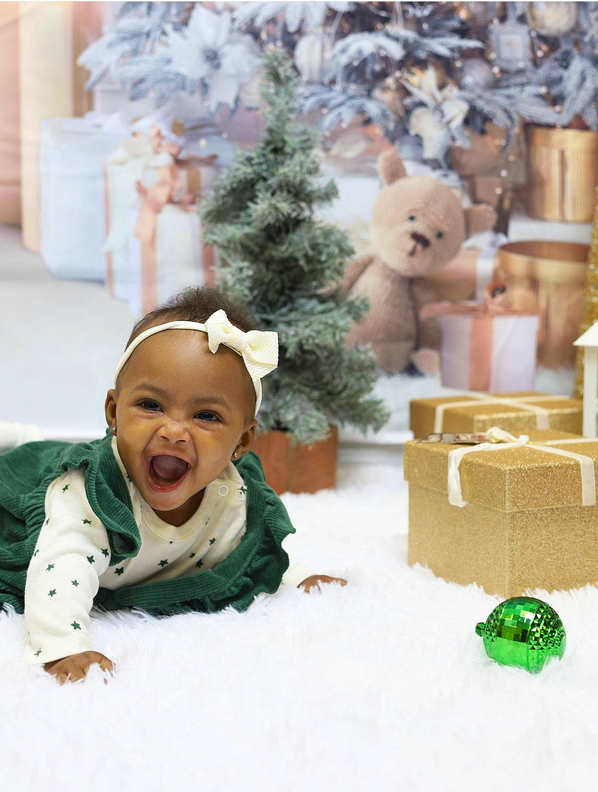 Ariel is registered to the contest to win money with this photo: baby, christmas, christmas_decoration, christmas_eve, christmas_ornament, christmas_tree, event, freezing, grass, green, happy, holiday, ornament, person, plant, smile, toddler, toy, tree, white