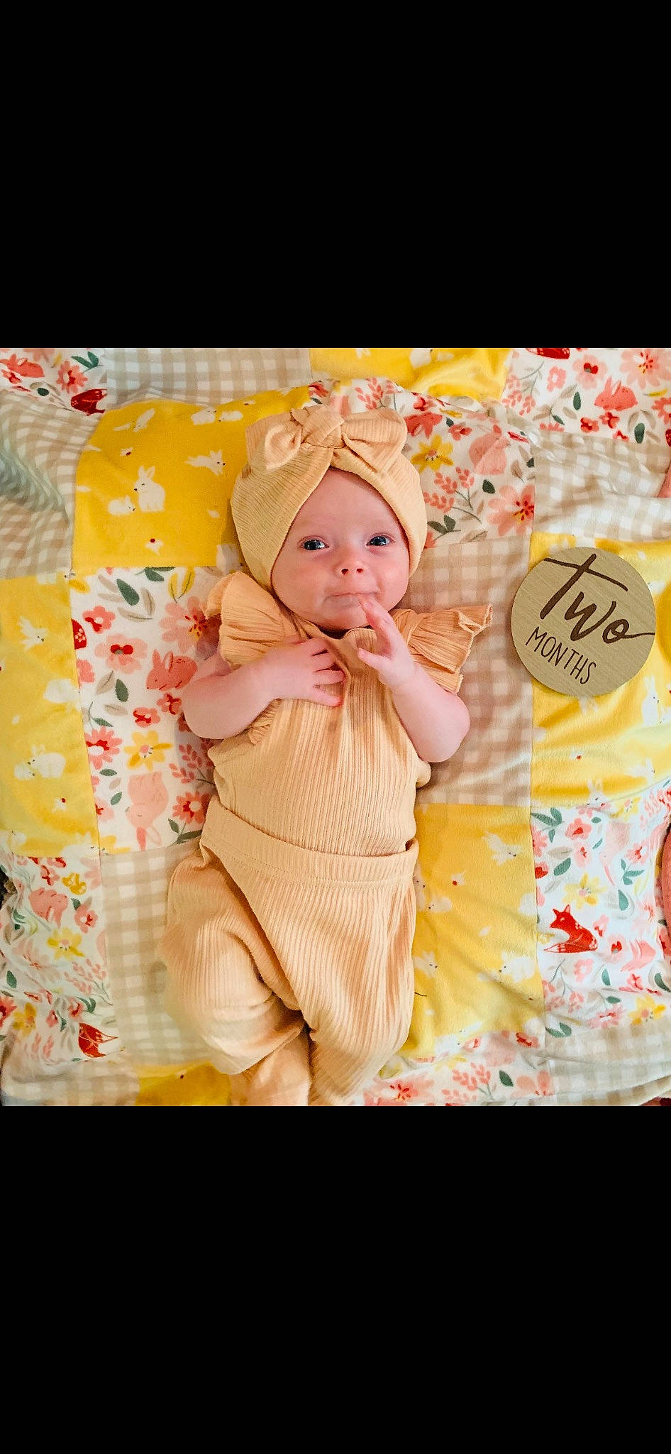Tatum is registered to the contest to win money with this photo: baby, baby_products, baby_toddler_clothing, bedding, child, clothing, font, fun, happy, headwear, linens, magenta, orange, pattern, peach, person, pink, portrait_photography, room, sitting