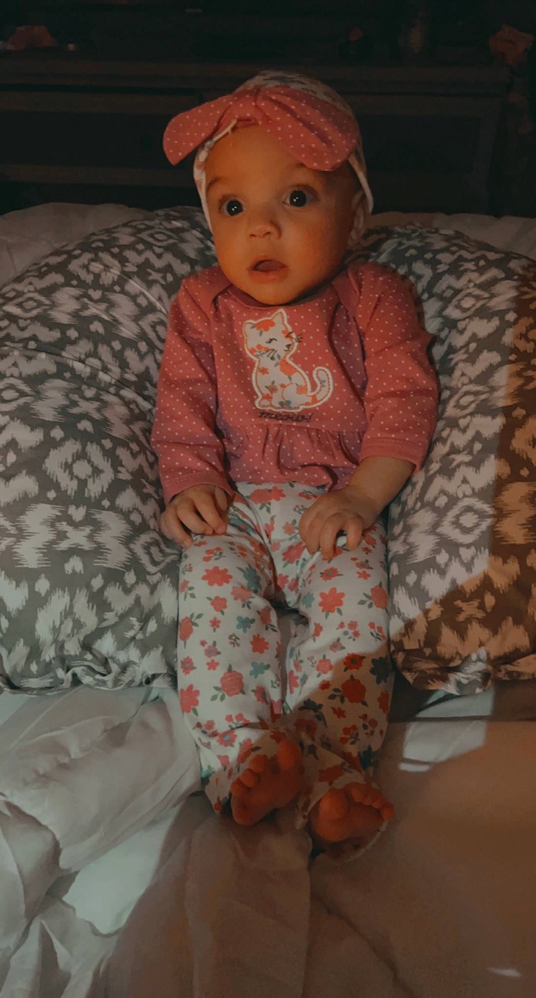 Jersey is registered to the contest to win money with this photo: baby, baby_toddler_clothing, cheek, chin, comfort, eye, face, facial_expression, head, headwear, iris, lip, mammal, neck, nose, person, pink, skin, sleeve, standing