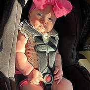 Laylah is registered to the contest to win money with this photo: baby, baby_girl, blue_eyes, car, car_seat, child, clothing, cute, expression, face, hand, harness, indoor, infant, pink_bow, safety, seatbelt, sitting, skin, sunlight