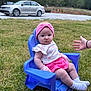 baby, child, purple_chair, grass, outdoor, pink_headband, floral_top, pink_shorts, socks, hand, person, car, vehicle, trees, nature, daylight, cute, sitting, young_child, plastic_chair