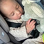 Omar is registered to the contest to win money with this photo: baby, child, car_seat, seatbelt, knitted_sweater, plush_toy, sleeping, infant, cozy, soft_toy, hand, cuteness, closeup, indoors, safety, resting, peaceful, cute, car_interior, child_safety
