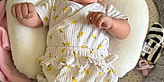 Grace joined the competition — help win amazing prizes! baby, infant, romper, lemon_pattern, pillow, blanket, pacifier, soft_toys, cushion, bed, clothing, person, cute, indoors, baby_accessories, comfortable, lying_down, skin, face, curious