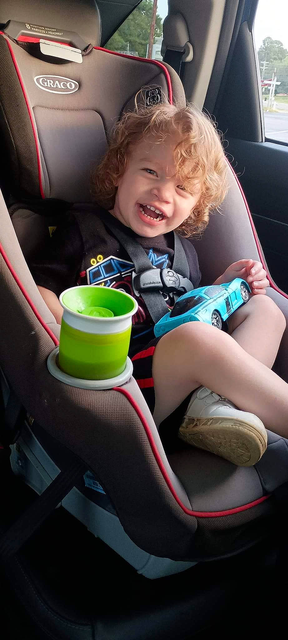 Danny joined the competition — help win amazing prizes! auto_part, automotive_design, automotive_exterior, automotive_wheel_system, baby_in_car_seat, car, car_seat, car_seat_cover, child, comfort, knee, motor_vehicle, person, plant, seat_belt, smile, steering_part, steering_wheel, thigh, toddler