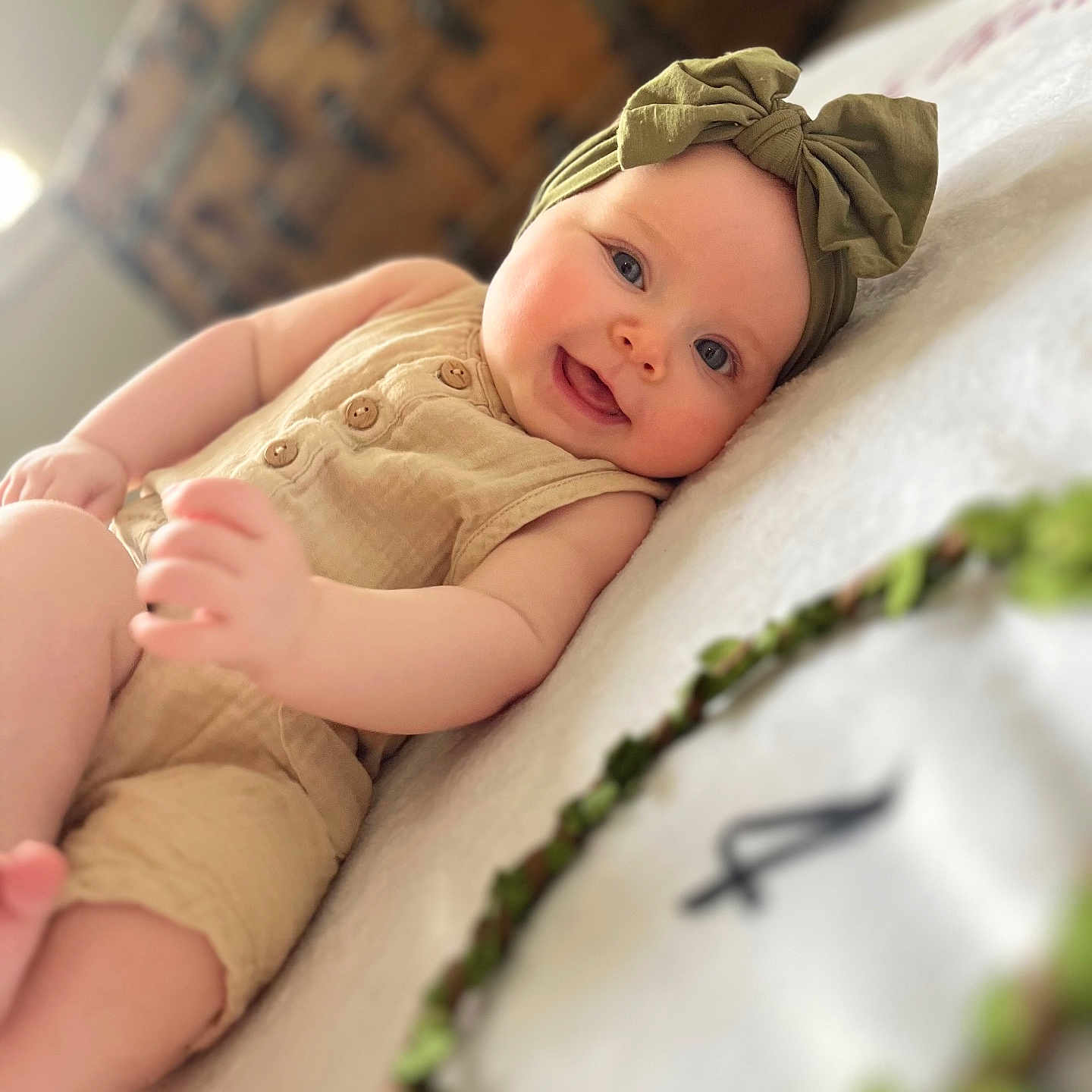 Brynn joined the competition — help win amazing prizes! baby, bed, bodypart, bonnet, cap, clothing, cushion, face, finger, furniture, hand, happy, hat, head, homedecor, newborn, person, photography, portrait, smile